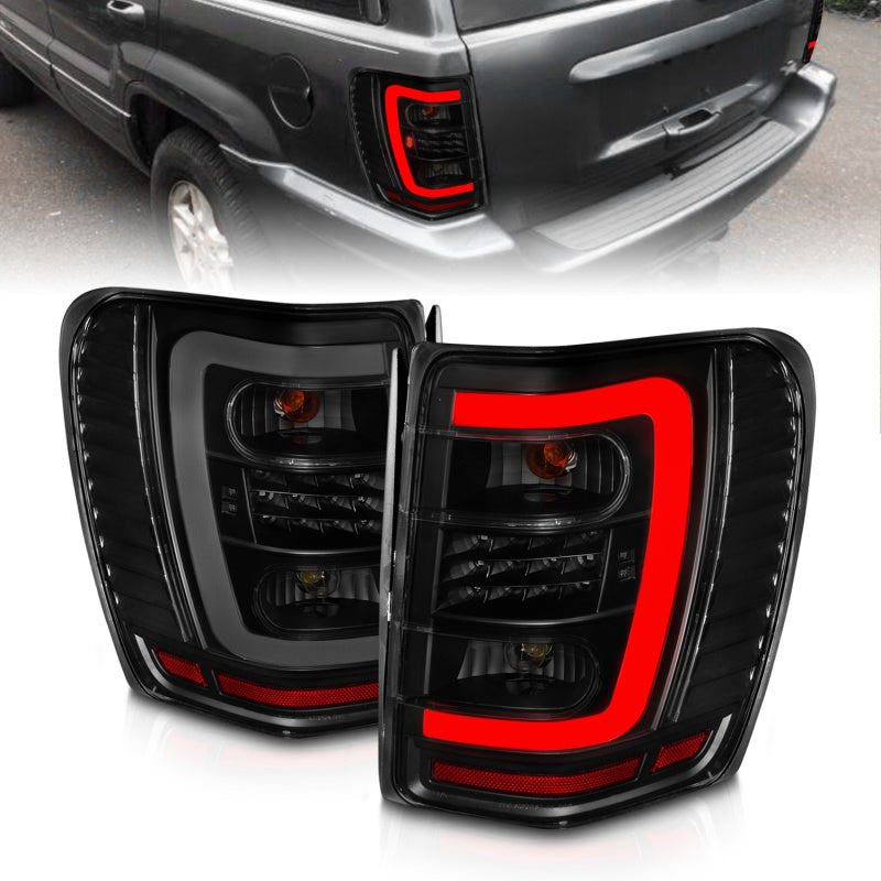 ANZO 1999-2004 Jeep Grand Cherokee LED Tail Lights w/ Light Bar Black Housing Smoke Lens 311395 311395 Photo - Primary
