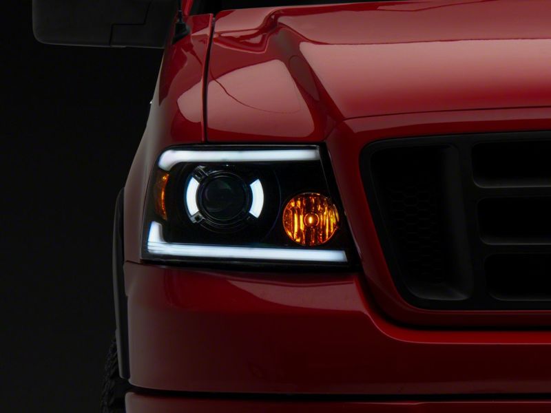 Raxiom 04-08 Ford F-150 Axial Series Projector Headlights w/ SEQL LED Bar- Blk Housing (Clear Lens) T566364 T566364 Photo - Close Up