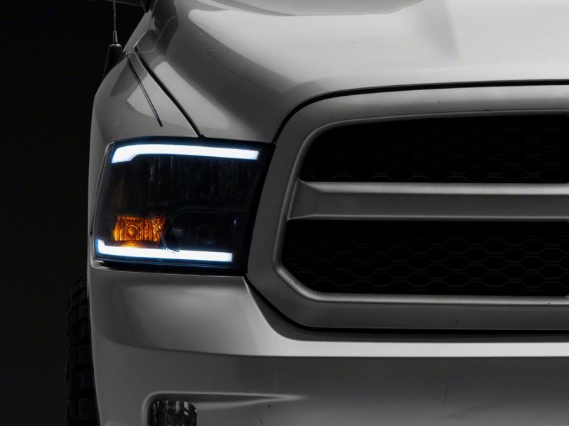 Raxiom 09-18 Dodge RAM 1500/2500/3500 Axial Series Headlights w/ LED Bar- Blk Housing (Clear Lens) R131481 R131481 Photo - Close Up