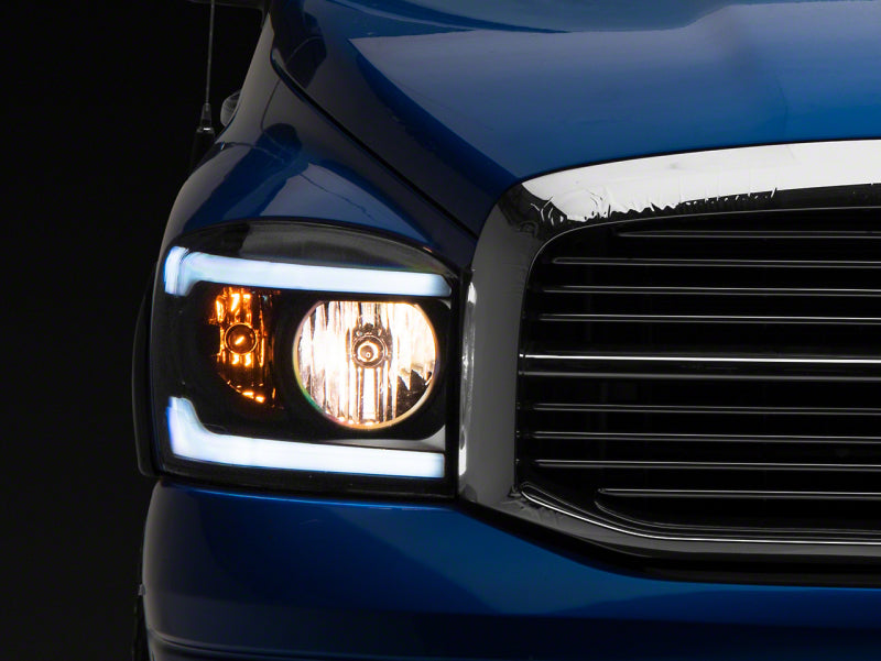 Raxiom 06-09 Dodge RAM 1500/2500/3500 Axial Headlights w/ SEQL LED Bar- Blk Housing (Clear Lens) R131480 R131480 Photo - Primary