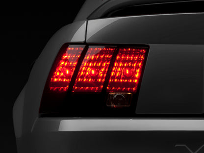 Raxiom 99-04 Ford Mustang Excluding 99-01 Cobra Tail Lights- Black Housing (Smoked Lens) 49080 49080 Photo - Primary