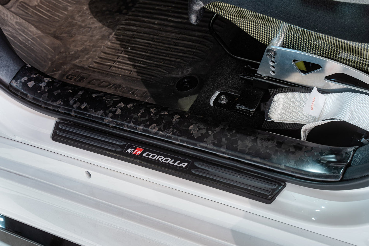 TOM'S Racing Forged Carbon Front Scuff Plate Cover - Toyota GR Corolla [2023+] / Toyota Corolla Hatchback [2019+]