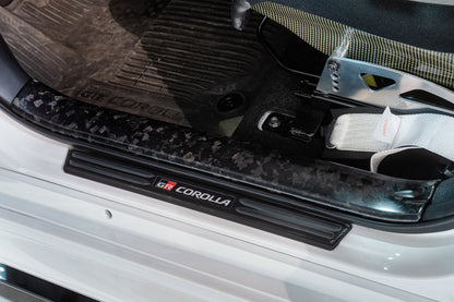 TOM'S Racing Forged Carbon Front Scuff Plate Cover - Toyota GR Corolla [2023+] / Toyota Corolla Hatchback [2019+]
