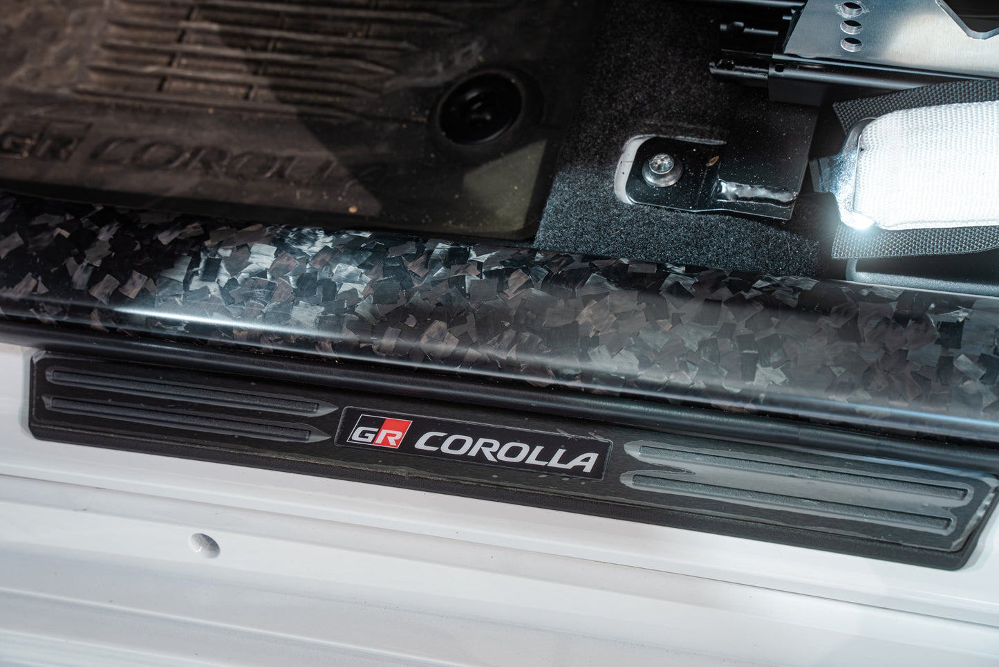 TOM'S Racing Forged Carbon Front Scuff Plate Cover - Toyota GR Corolla [2023+] / Toyota Corolla Hatchback [2019+]