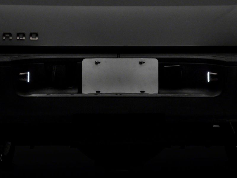 Raxiom 01-13 Chevrolet Silverado/GMC Sierra 1500 Axial Series LED License Plate Lamps- Smoked S122507 S122507 Photo - Close Up
