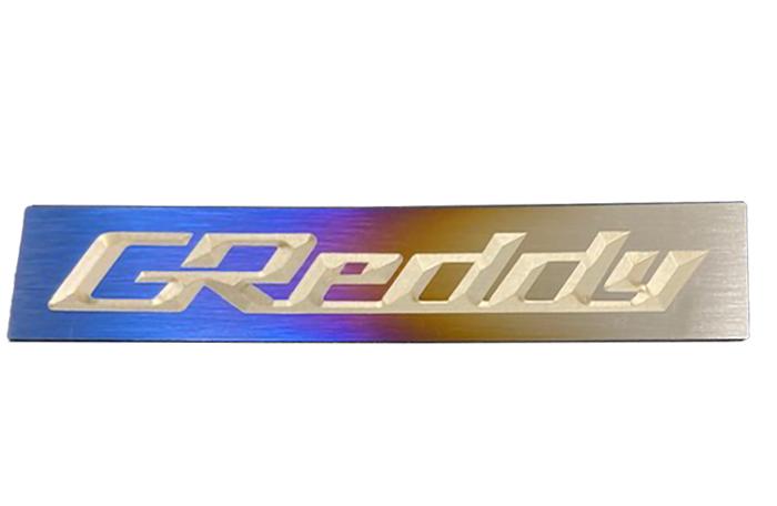 GReddy Optional Titanium GReddy Emblem - (105x20mm)