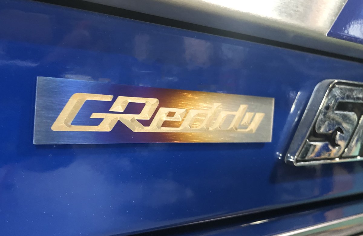 GReddy Optional Titanium GReddy Emblem - (105x20mm)